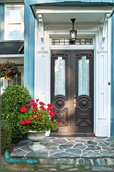 Double front door of luxurious landscaped home