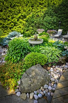 Lush perennial garden with fountain plants and trees