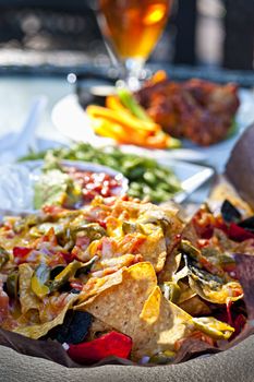 Basket of nachos and other appetizers on restaurant table