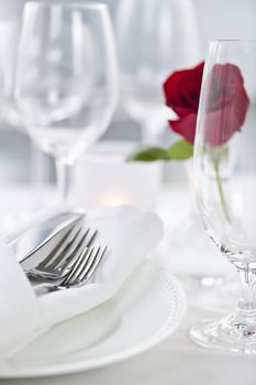 Romantic table setting with rose plates and cutlery