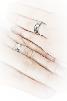 Closeup on hands of married couple with wedding rings