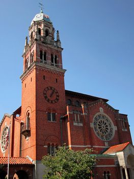 A photograph of a church bell tower detailing its unique architectural design.
