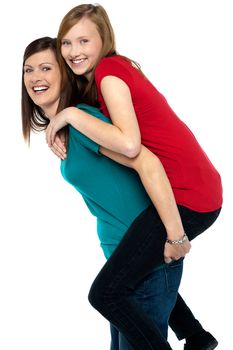 Happy mother giving piggy back ride to her daughter isolated on white background.