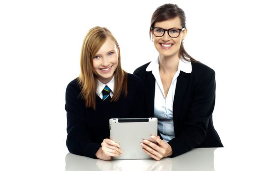 Teacher and student holding tablet device together. Isolated over white.