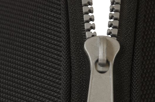 close up of half opened zipper with black fabric on white background