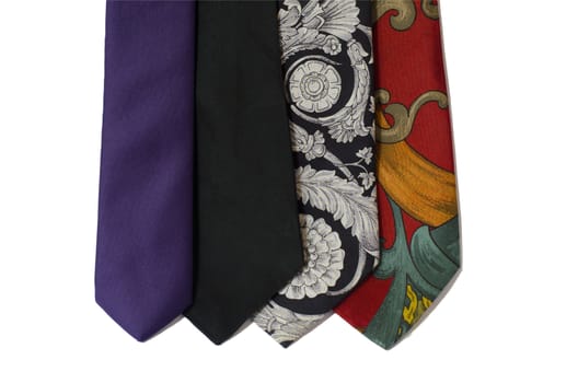 four neckties in different colors hanging isolated on white