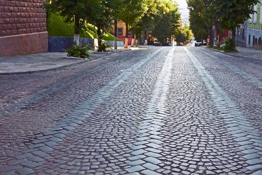 Wide cobbled road in old town at the summer morning. Lviv, Ukraine