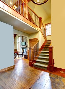 Mountain luxury home staircase with wood railings.