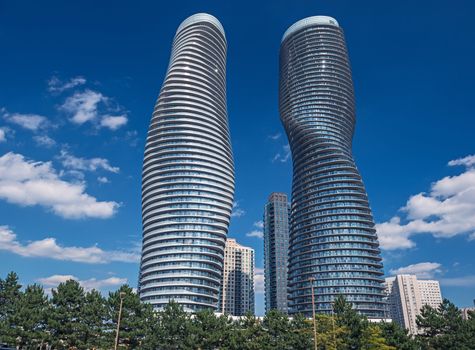 The Absolute World condominium Towers in the city center of Mississauga Ontario on a sunny afternoon. The hourglass shaped tower has been nicknamed the Marilyn Monroe tower due to the curvy shape. 