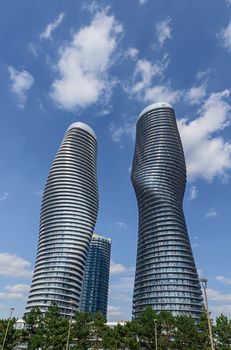 The Absolute World condominium Towers in the city center of Mississauga Ontario on a sunny afternoon. The hourglass shaped tower has been nicknamed the Marilyn Monroe tower due to the curvy shape. 
