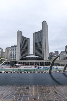 Toronto, Canada - July 10, 2012: Toronto's landmark curved towers of New City Hall overlooking Nathan Phillips Square. Preparing skate ring before winter. People preparing for parade. 