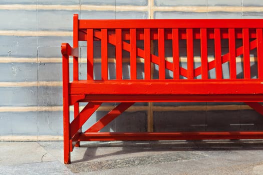 Red Bench Against brick wall