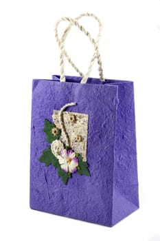 Purple mulberry paper bag isolated with flower.