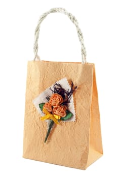 Orange mulberry paper bag isolated with flower.