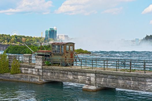 Abandoned and rusted rail crane on bridge at Niagara River just above Horseshoe Falls in Canada