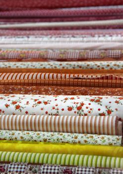 Big assortment of fabrics in the textile store 