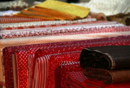 Big assortment of fabrics in the textile store