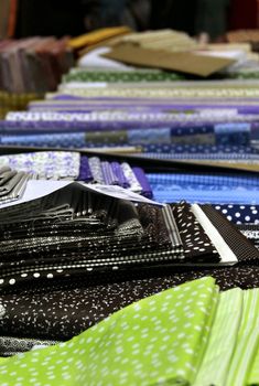 Big assortment of fabrics in the textile store 
