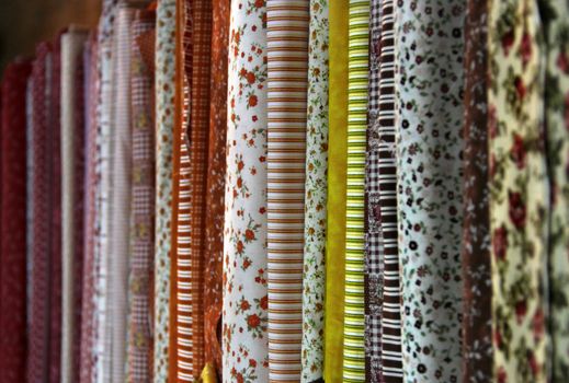 Big assortment of fabrics in the textile store 