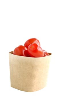 Tomatos in paper bag isolated on white background