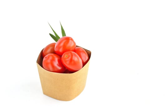 Tomatos in paper bag isolated on white background