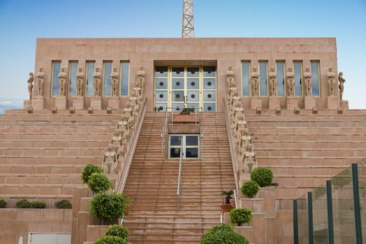 building with statute of naked woman at the stairs