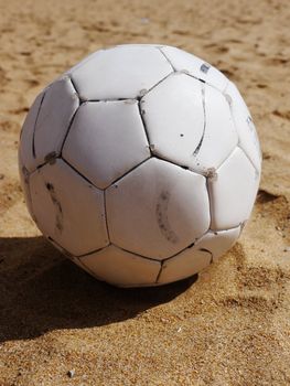 soccer ball on a beach in white leather
