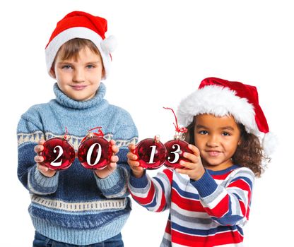 Kids in Santa's hat holding a christmas ball with 2013 against a white background. Focus on the ball