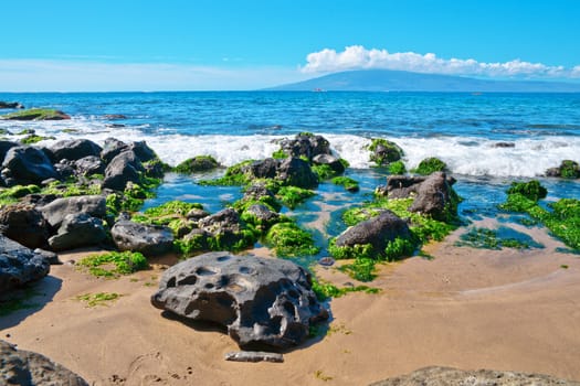 Rocks and sand along the  Bay on the island of Maui, Hawaii. 