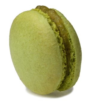 Image of a traditional French green macaron against a white background.