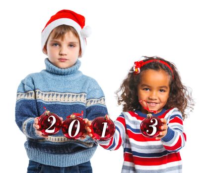 Kids in Santa's hat holding a christmas ball with 2013 against a white background. Focus on the ball