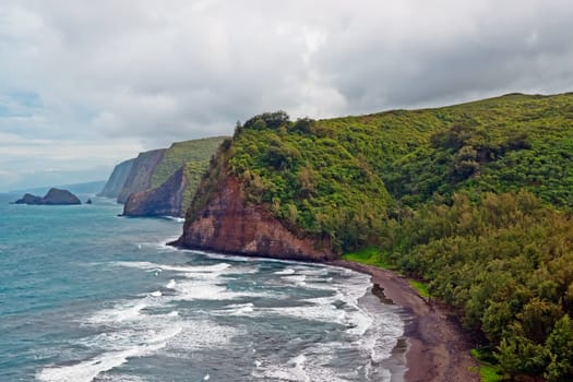 Pololu Beach on the Big Island of Hawaii. Passing the 28 mile marker on Highway 270 past Hawi it is a breathtaking view of Polulu Valley. It's a 30 minute hike over rough ground. But worth it