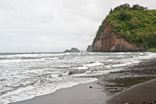 Pololu Beach on the Big Island of Hawaii. Passing the 28 mile marker on Highway 270 past Hawi it is a breathtaking view of Polulu Valley. It's a 30 minute hike over rough ground. But worth it