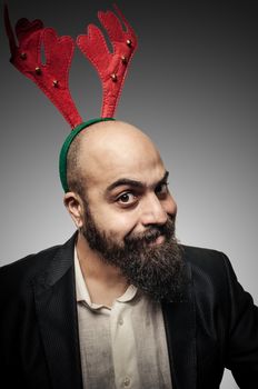 christmas bearded man with funny expressions on grey background