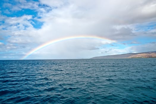 Beautiful rainbow in Hawaii, Pacific ocean. shoreline of Kauai Island