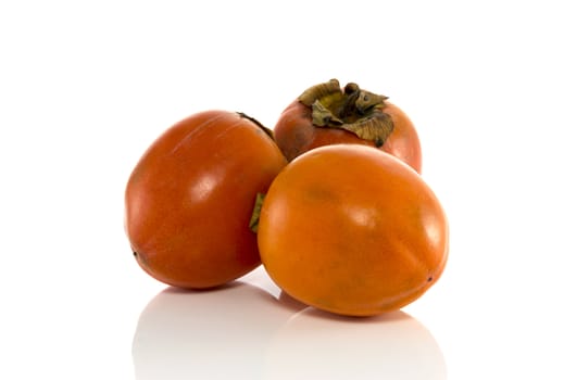3 kaki fruits from asia isolated on white