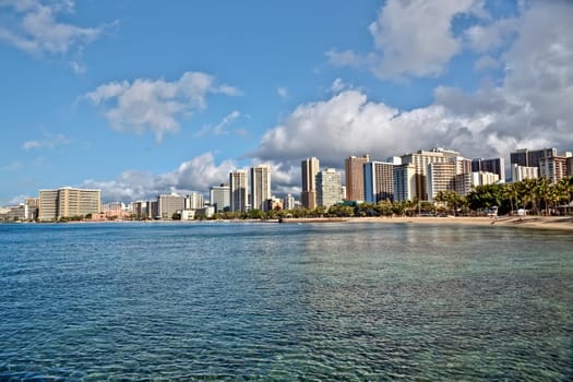 Cityscape Waikiki Beach, Honolulu Hawaii, USA.  Waikiki beach is a popular spot in the city of Honolulu to swim, surf, and relax