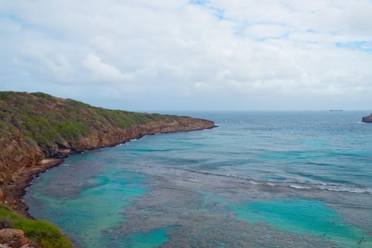 View of Hanauma Bay, Oahu, Hawaii. Hanauma Bay is formed within a volcanic cone and located along the southeast coast of the Island of Oahu. It is a protected marine life conservation area and snorkeling spot on the island.
