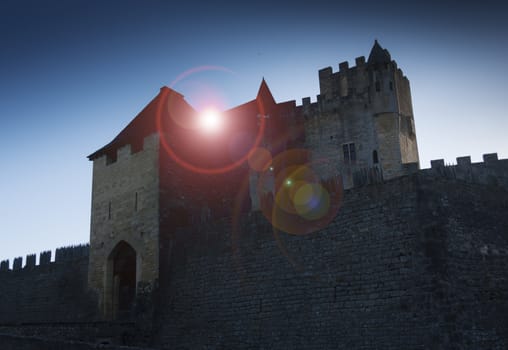 Medieval French castle shot with back lighting and added lens flare for drama