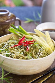 Spinach noodle salad with baby corn,spring onion and soysauce and sesame dressing