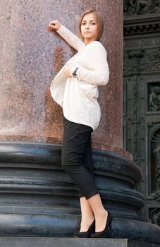 beautiful girl on the background of the marble columns