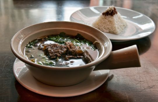 bowl of soup with meat and rice packed pyramid