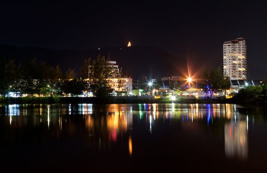 view the city at night, the reflection in the sea