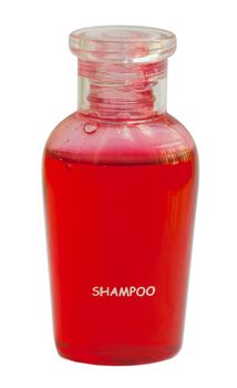 Small red bottle of shampoo isolated on white background