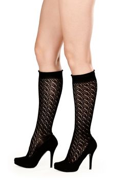 female legs in fishnet socks and shoes on high heels in the studio on a white background