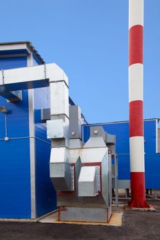 Biofuel boiler house against the blue sky