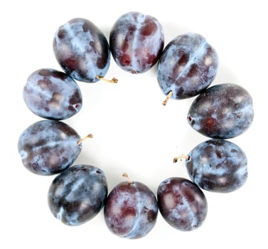 Ripe plums arranged around isolated on a white background