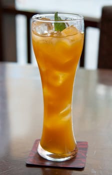 cocktail, mango juice with ice cubes in a glass