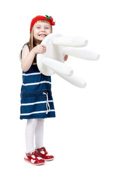 beautiful little girl in red cap holding a plastic chair in the hands of