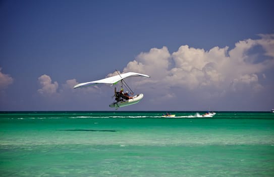 Ocean view of a boat gliding over a cloudy sky